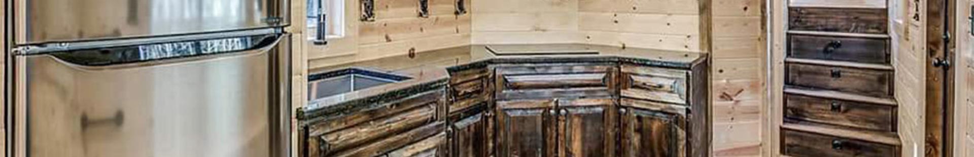 Interior view of wood-lined kitchen in a tiny home in Muskogee, OK