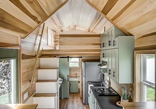  Interior view of tiny house from kitchen with stairs to loft.