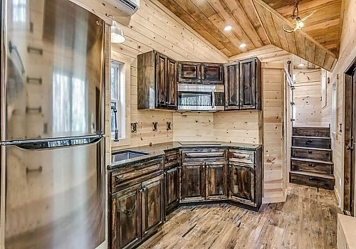  View of tiny house kitchen and stairs.