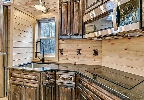  Wood-lined kitchen in Leonard, OK tiny house.