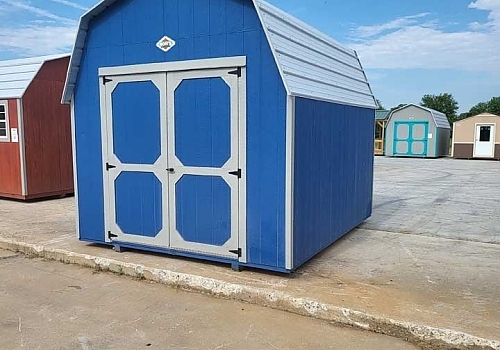 Blue higih-roof shed with white trim.