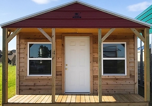 Front view of brown wood cabin | Muskogee, OK
